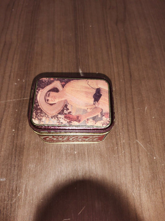 1988 Coca Cola Tin with Lid - Lady with Big Hat holding a Bottle of Coke 4"X2.5"