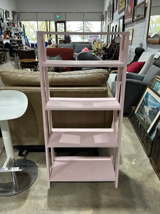Pink leaning bookshelf