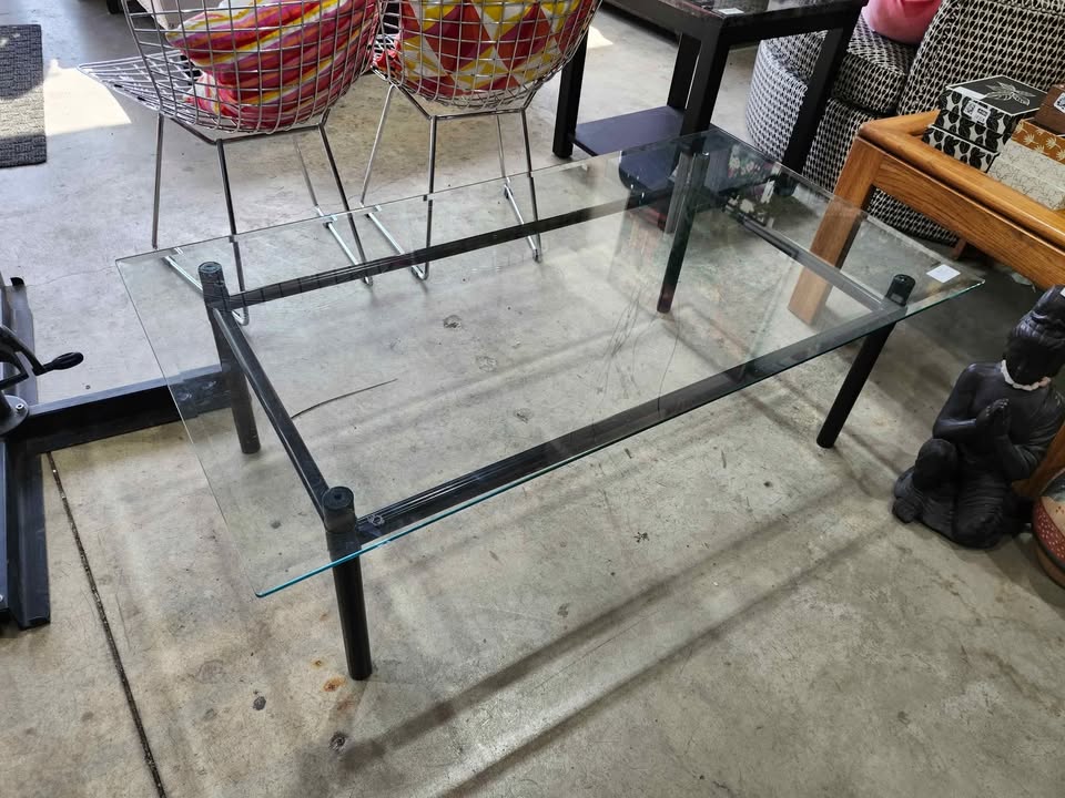Glass top coffee table with black metal frame