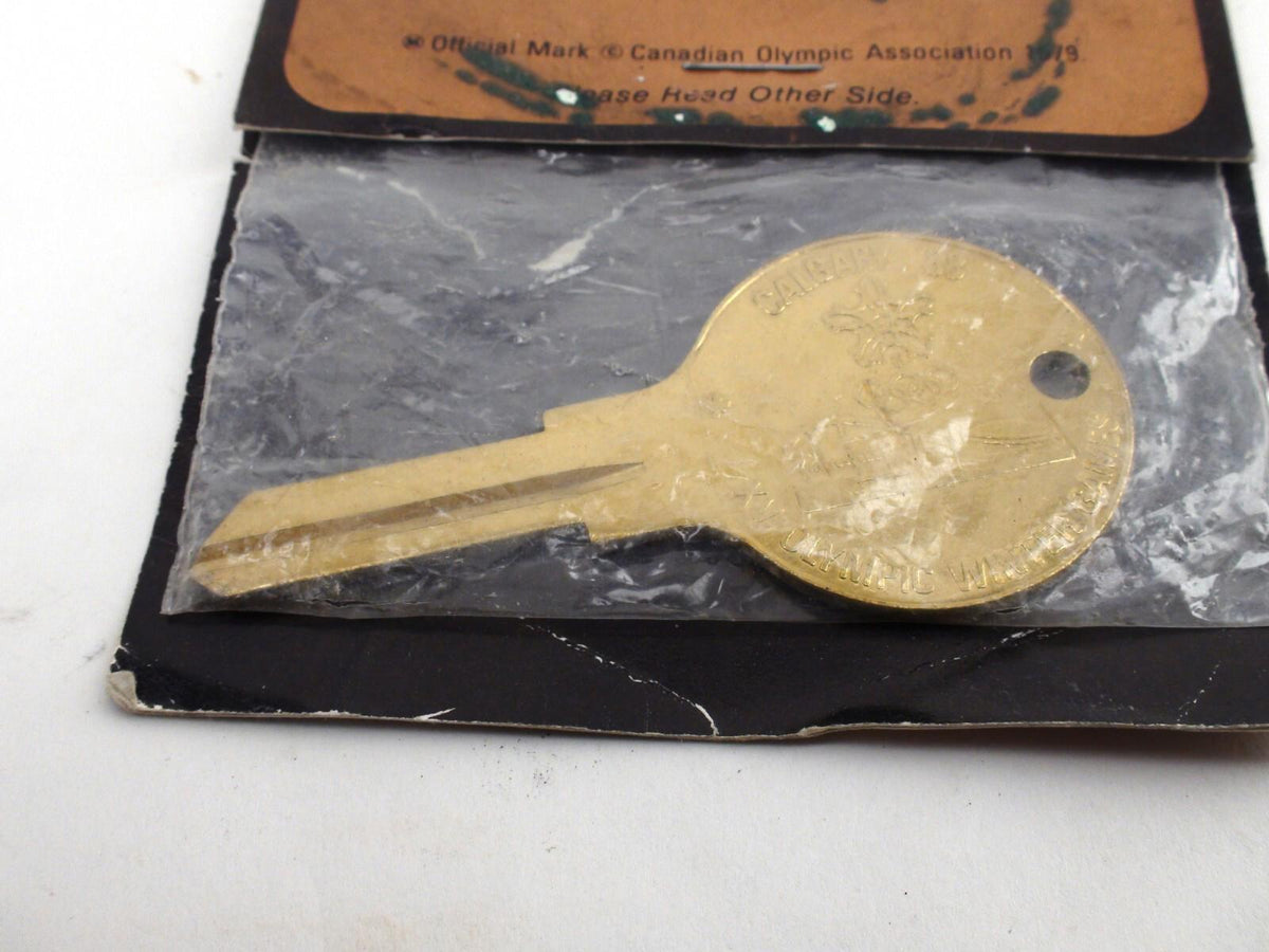 '88 Calgary Winter Olympic Souvenir Key, Uncut In Damaged Packaging - Brass