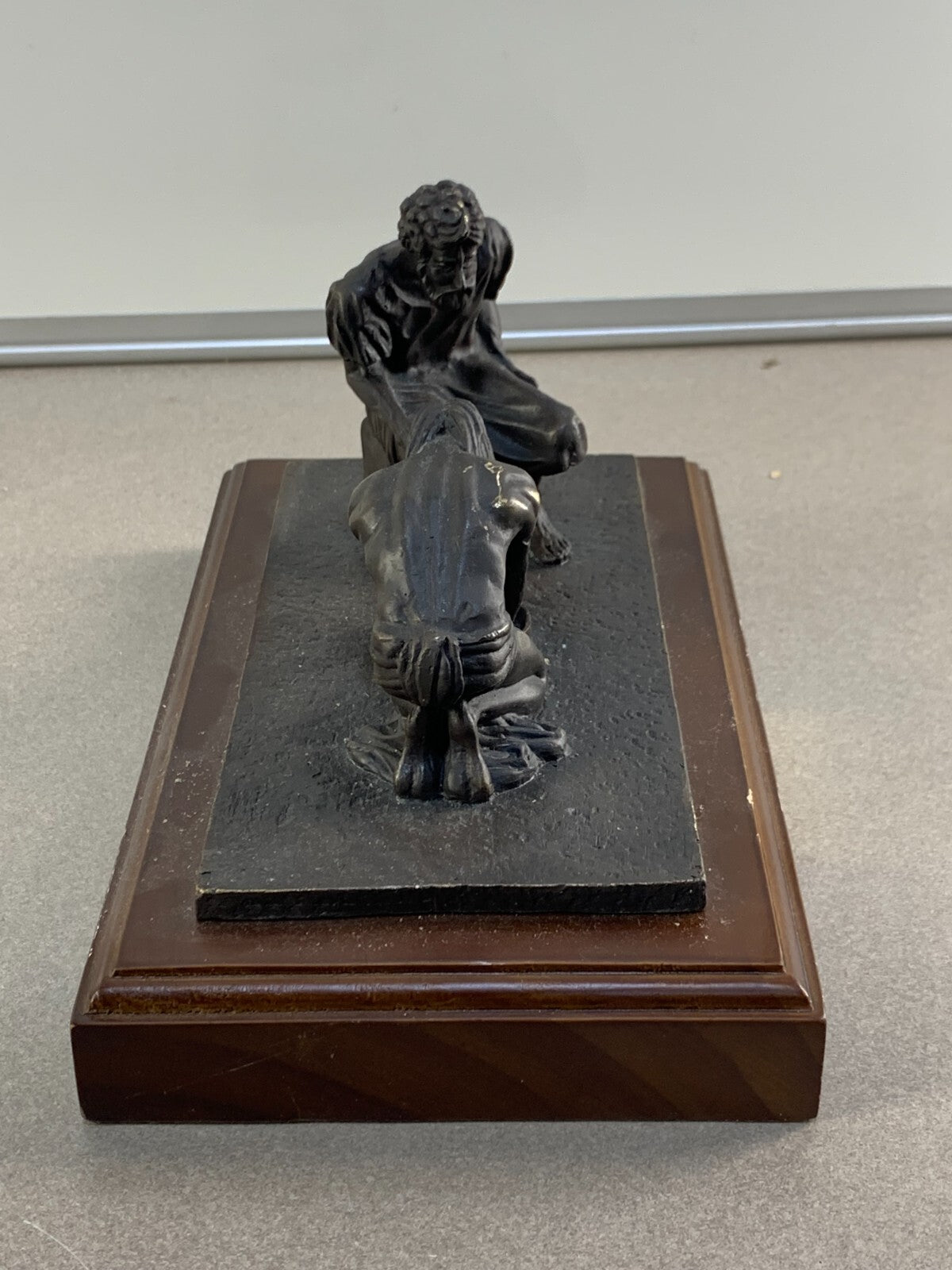 Bronze statue of Jesus washing the feet of Peter, at the last Supper.