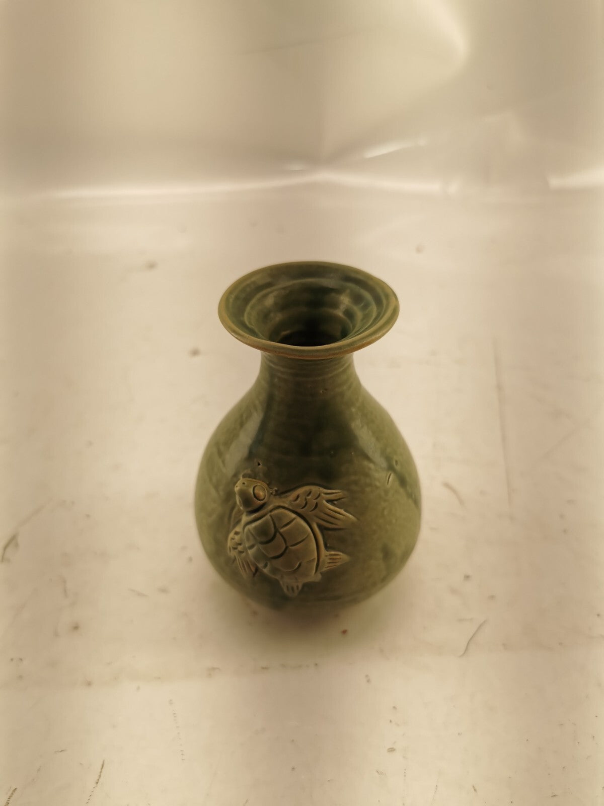 Green vase with a turtle