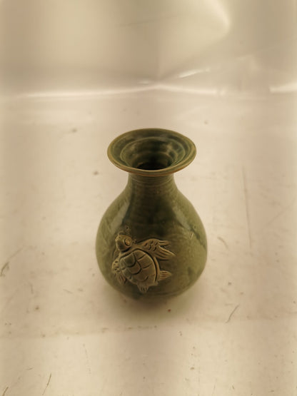 Green vase with a turtle