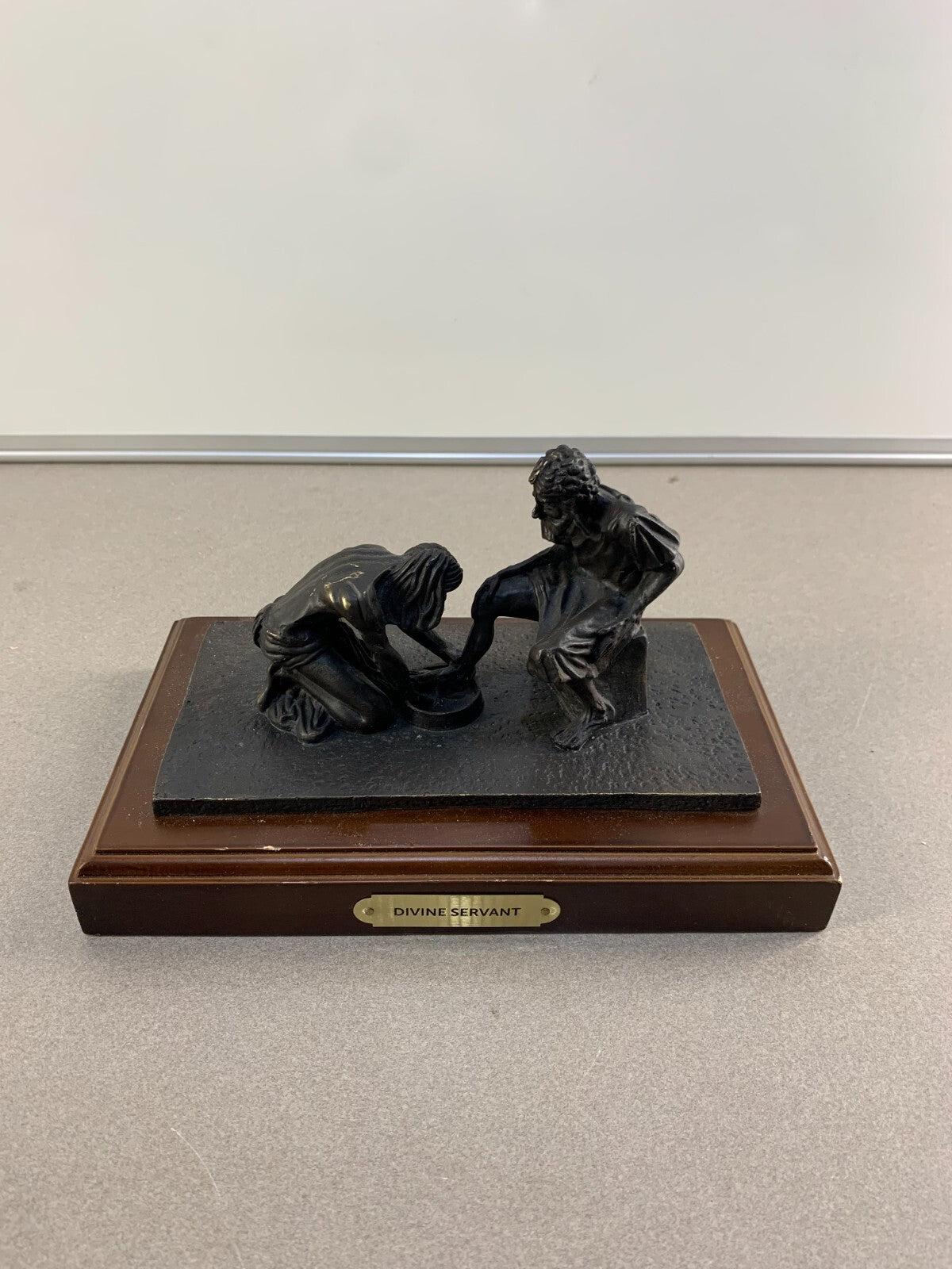 Bronze statue of Jesus washing the feet of Peter, at the last Supper.