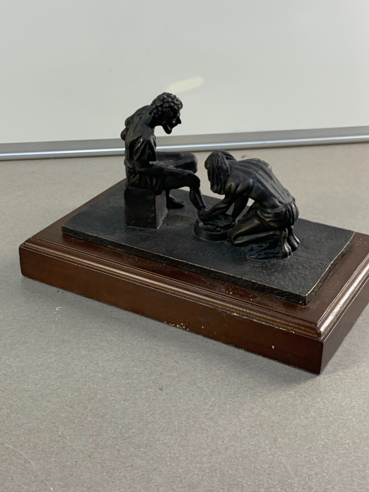 Bronze statue of Jesus washing the feet of Peter, at the last Supper.