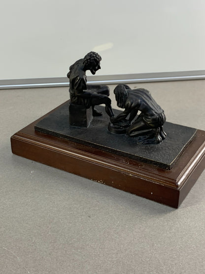 Bronze statue of Jesus washing the feet of Peter, at the last Supper.