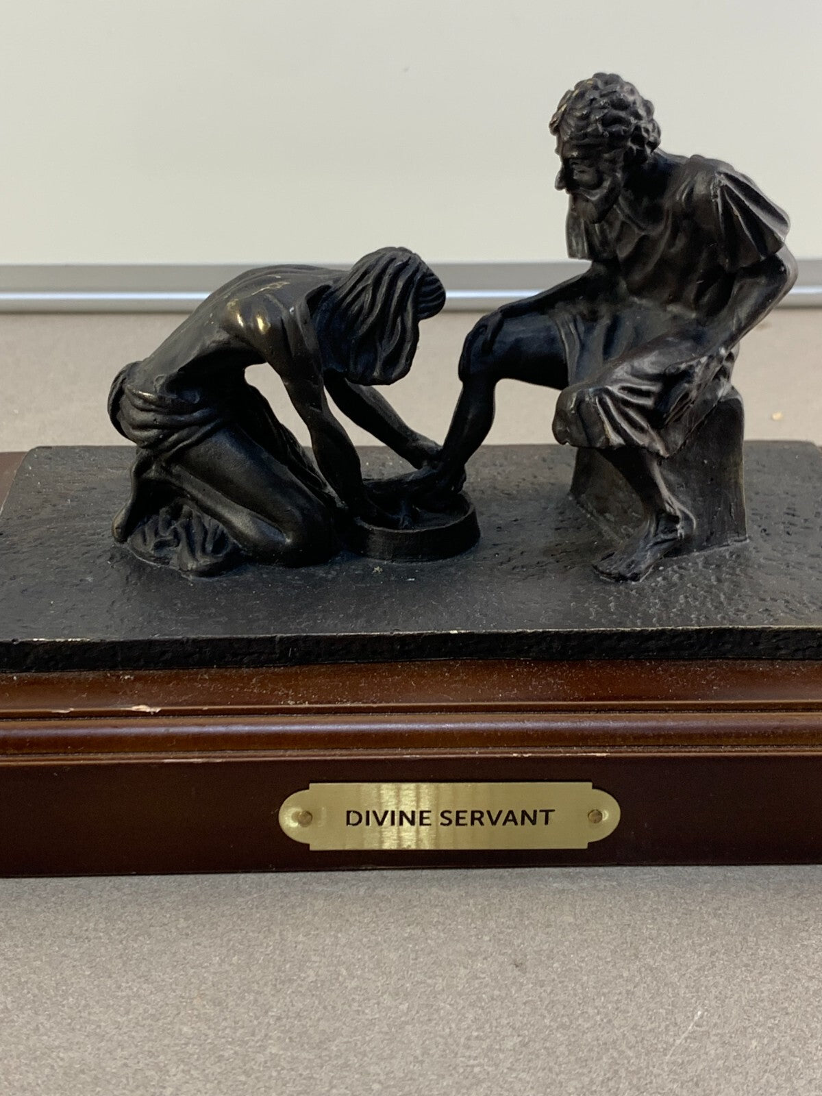 Bronze statue of Jesus washing the feet of Peter, at the last Supper.