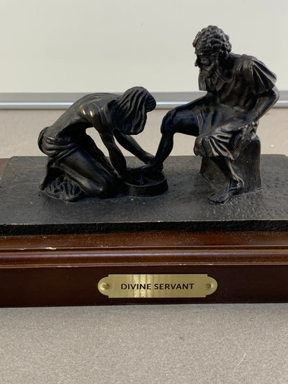 Bronze statue of Jesus washing the feet of Peter, at the last Supper.