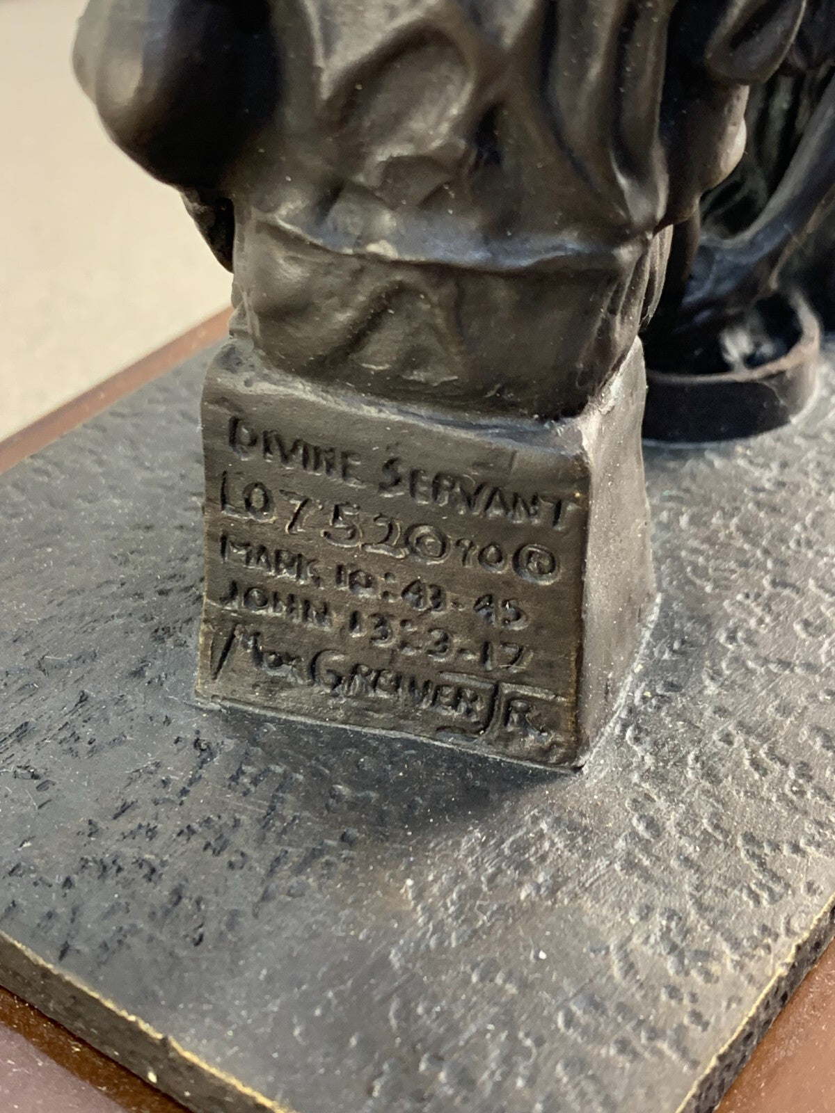 Bronze statue of Jesus washing the feet of Peter, at the last Supper.
