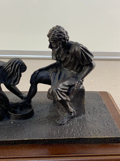 Bronze statue of Jesus washing the feet of Peter, at the last Supper.