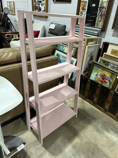 Pink leaning bookshelf