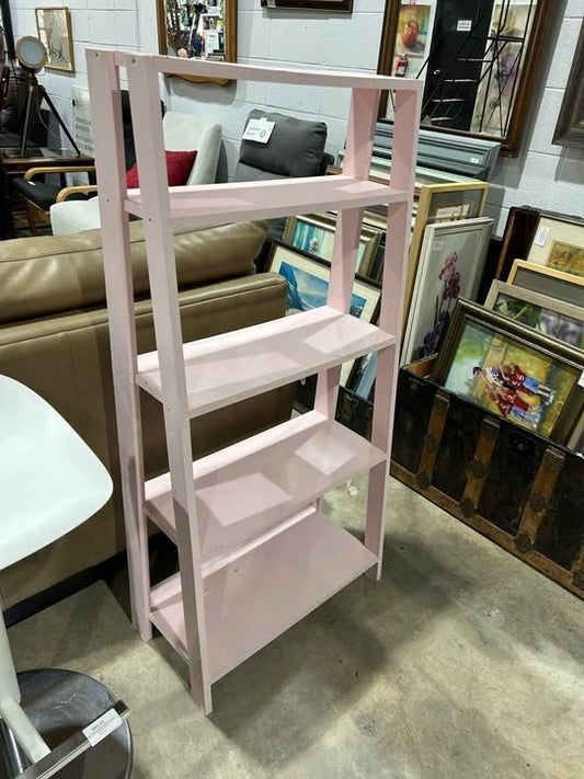 Pink leaning bookshelf
