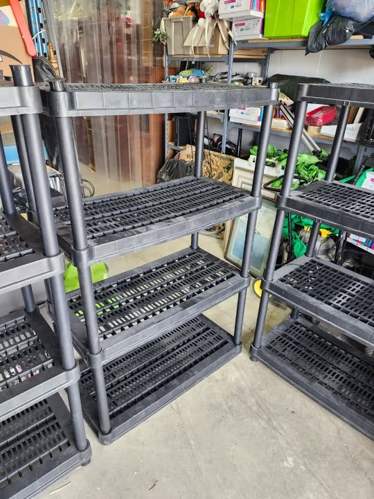 Three Black Plastic Adjustable Shelving Racks
