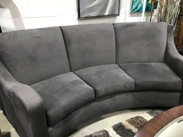 Curving grey sofa